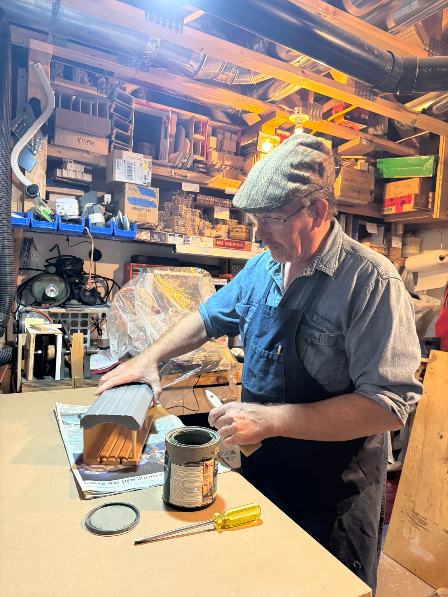 Mitch applying the finish to a handmade wooden railway station