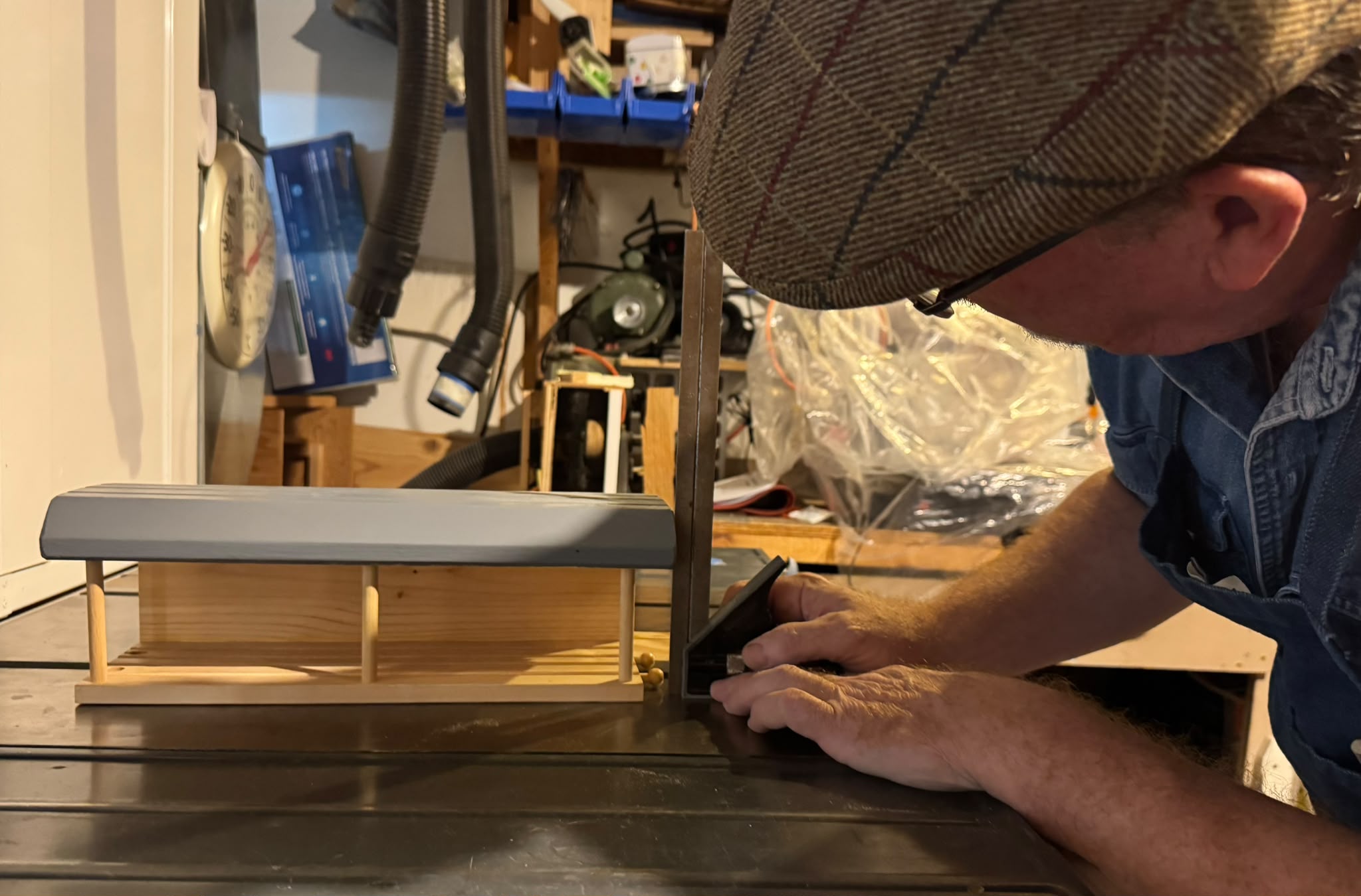 Mitch checking the fit of a handmade wooden railway station
