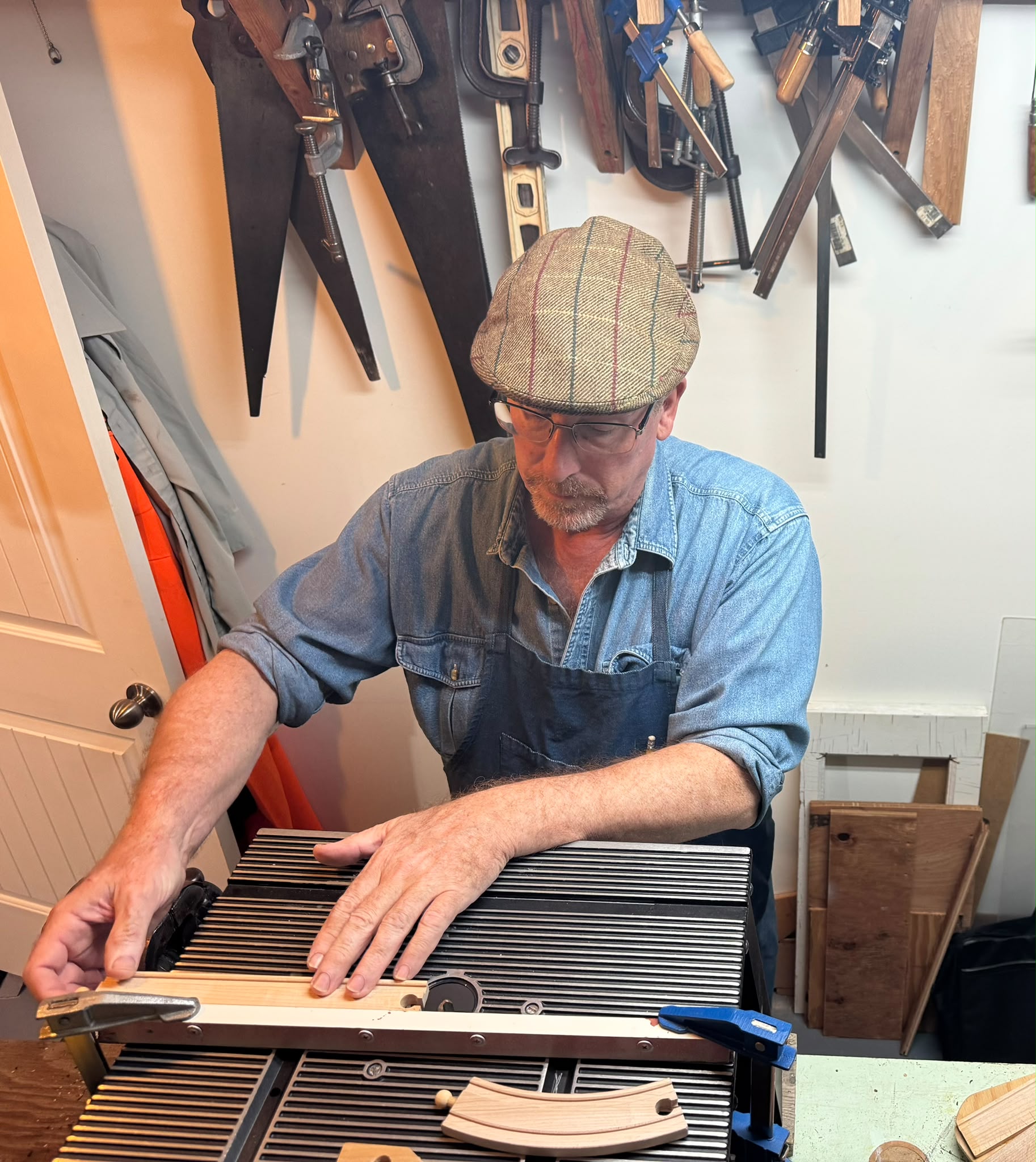 Mitch fitting a handmade wooden track in his workshop